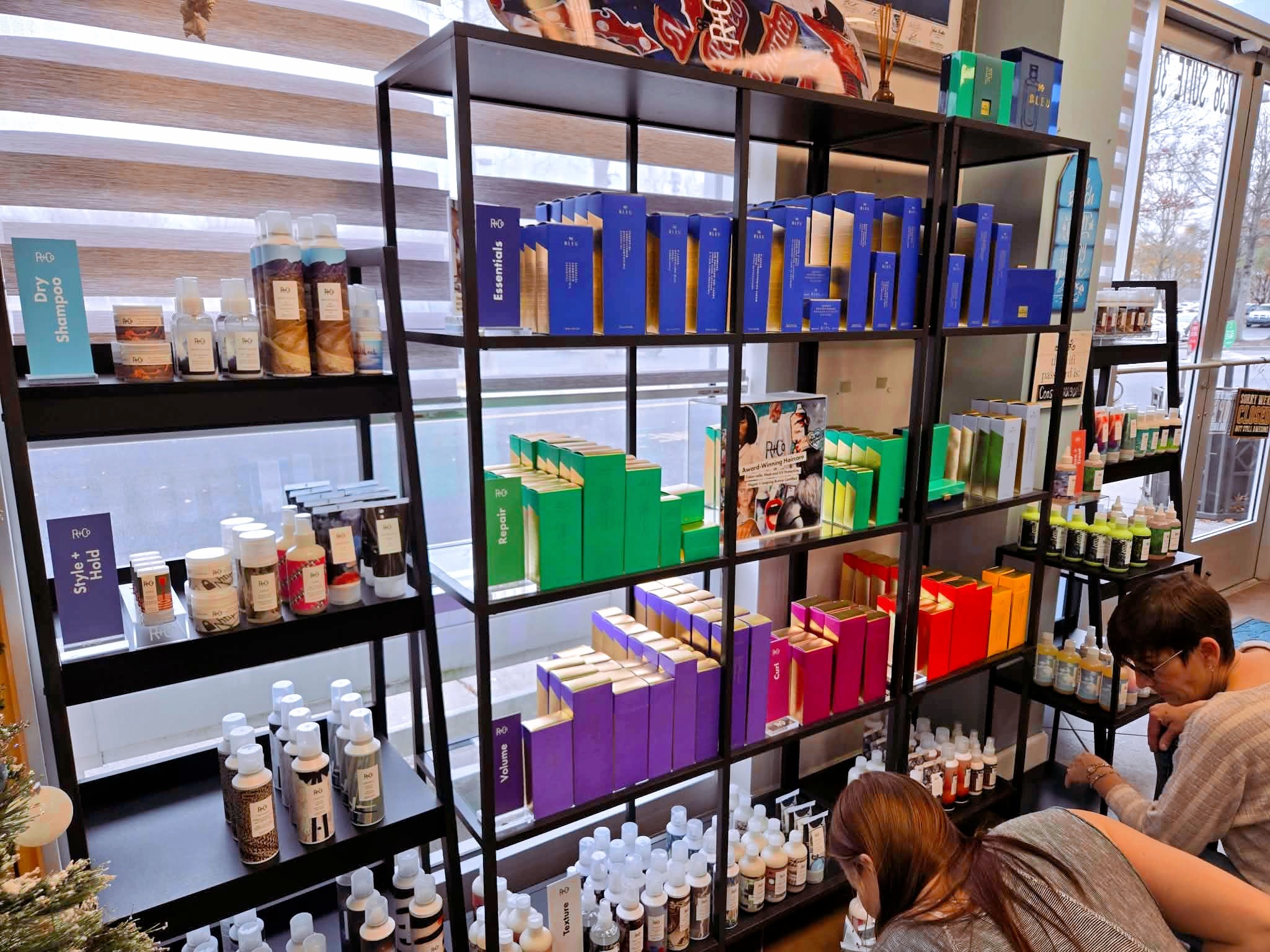 Haircare product and education display at Coastal Roots Salon