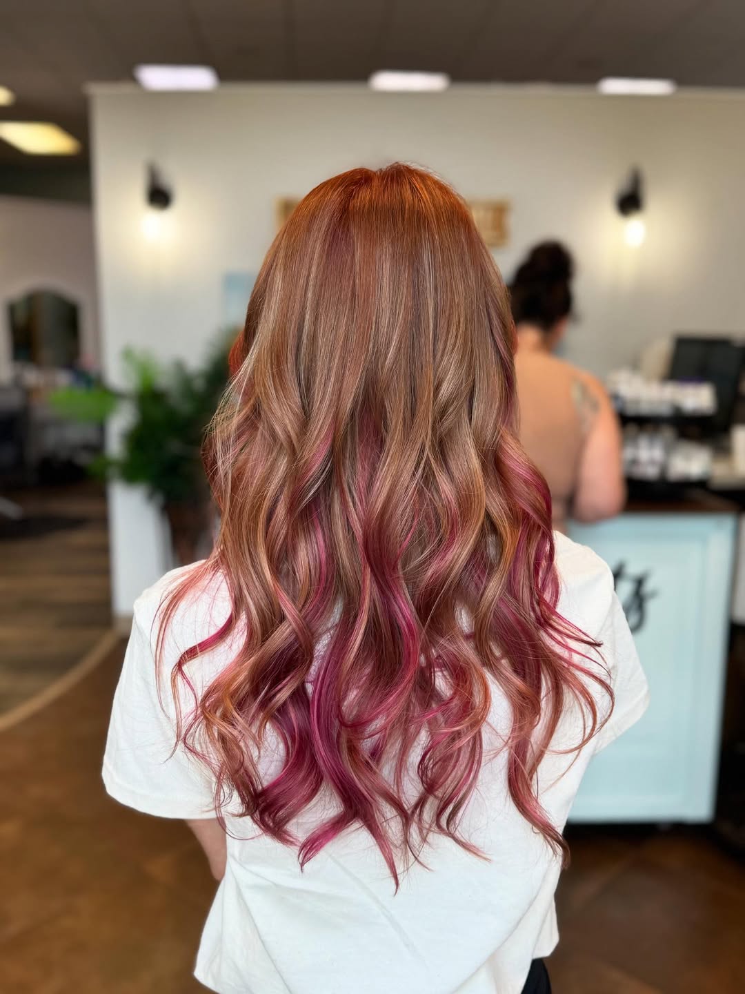 Bold pink hair color by Coastal Roots Hair Salon