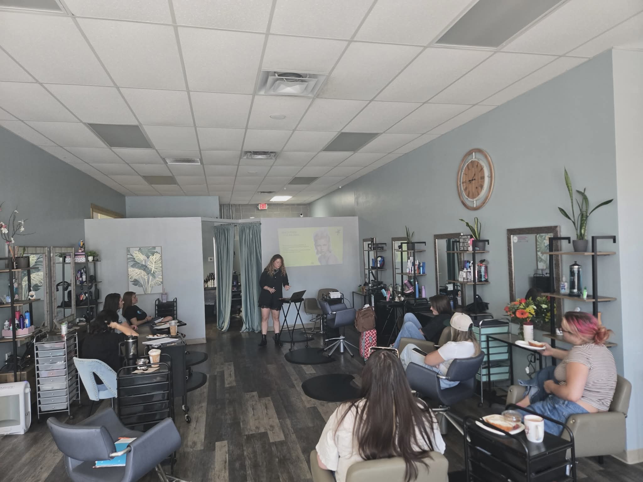 Coastal Roots Salon team learning about layering techniques and product education during an in-salon class